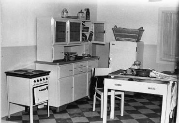 This (believe it or not) 1954 photo of a German kitchen shows the essential "moving parts" found in all kitchens across the globe:  the stove, Hoosier (or cabinet), and a table for eating and food prep ... sink optional (believe it or not!).  Kitchens have certainly come a long way as far as lavishness and permanency.  Regardless of size and style, kitchens always have been and still are considered the Heart of the Home.  Photo is by Hans-Ginter Quaschinsky, is from the German Federal Archives, and is used courtesy of the Creative Commons ShareAlike Attribution 3.0 Germany License. (http://commons.wikimedia.org/wiki/File:Bundesarchiv_Bild_183-23747-0002,_Berlin,_Berolinahaus,_Ausstellung,_Kunststoff-K%C3%BCche.jpg)